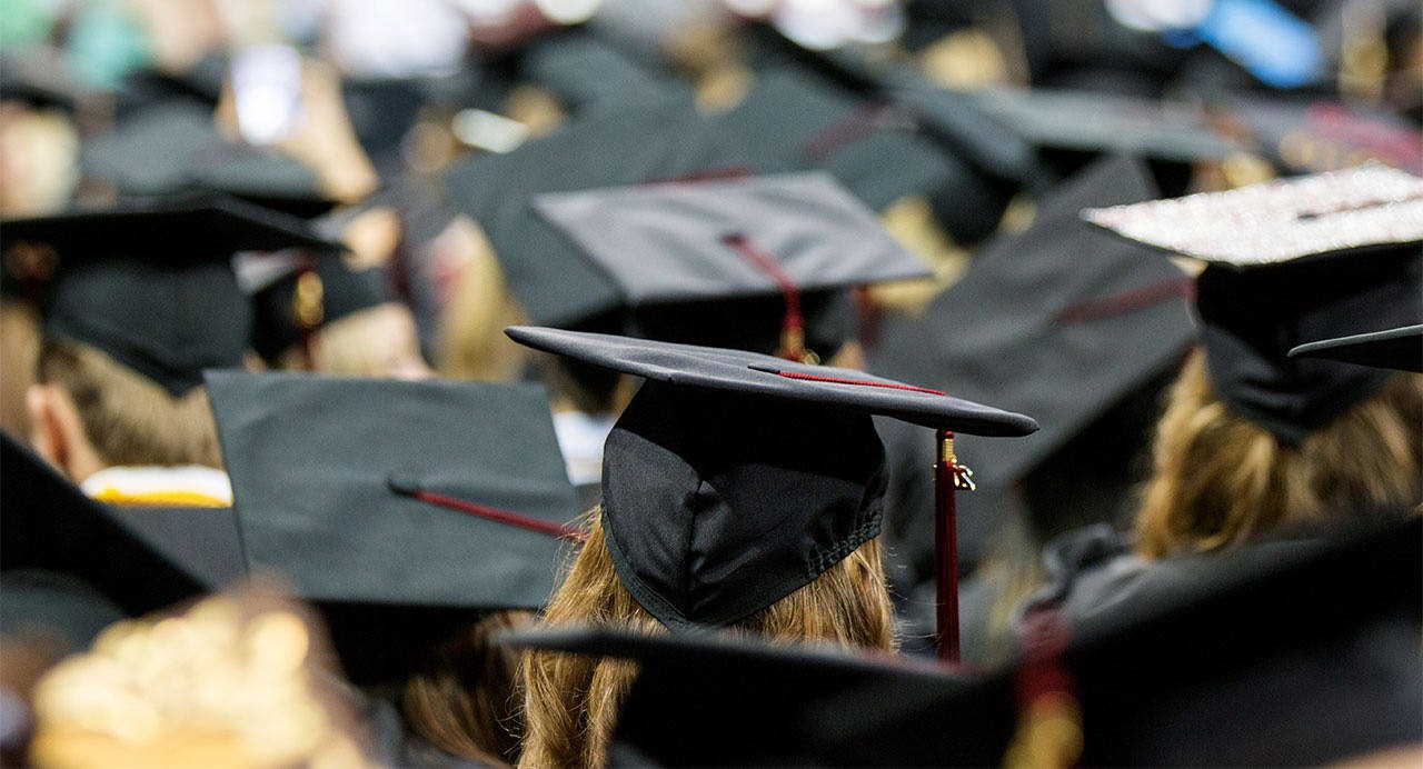 University of South Carolina graduates sit at a ceremony.